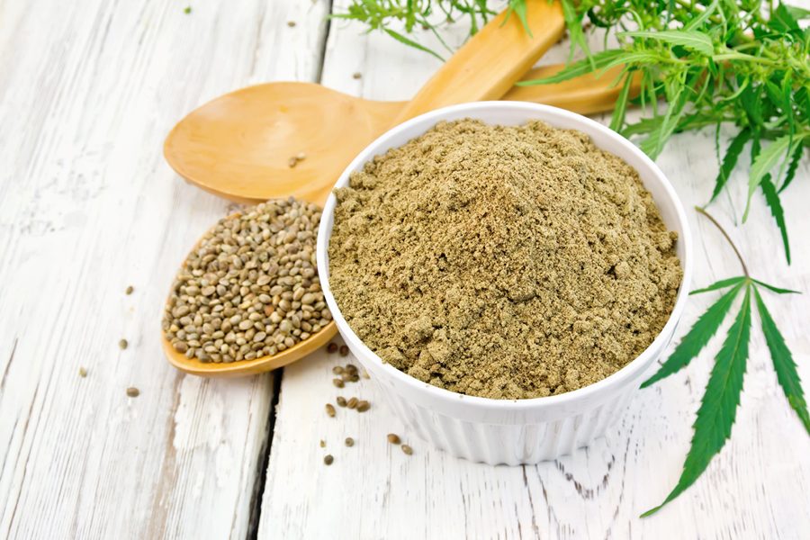 Flour hemp in bowl with spoons on board